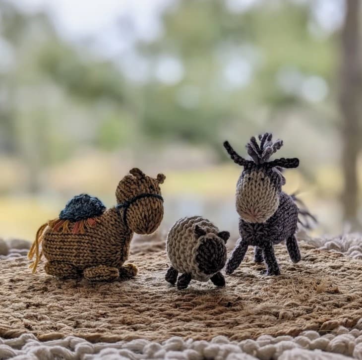 Hand-knit barnyard animals — sheep, donkey, and cow